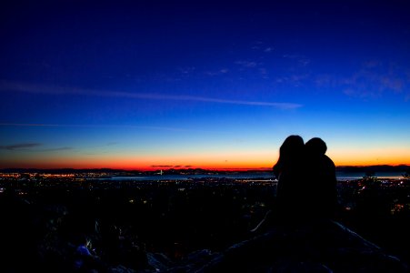 Silhouette Of Couple Holding Each Other At Sunset