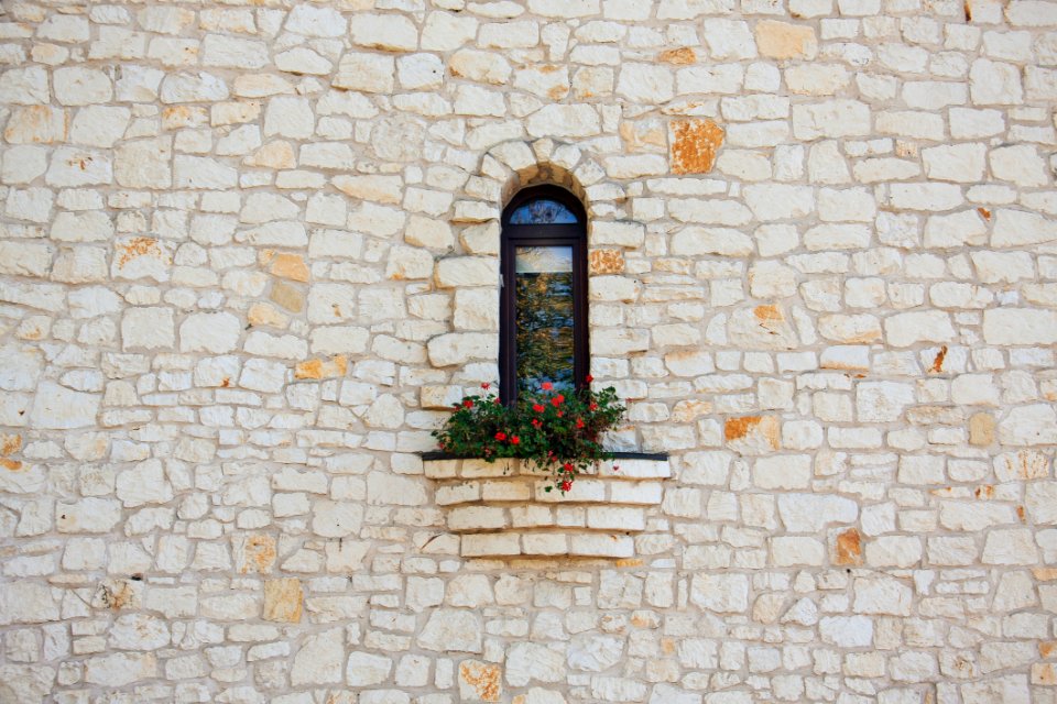 White Stone Wall With Flower Box In Window