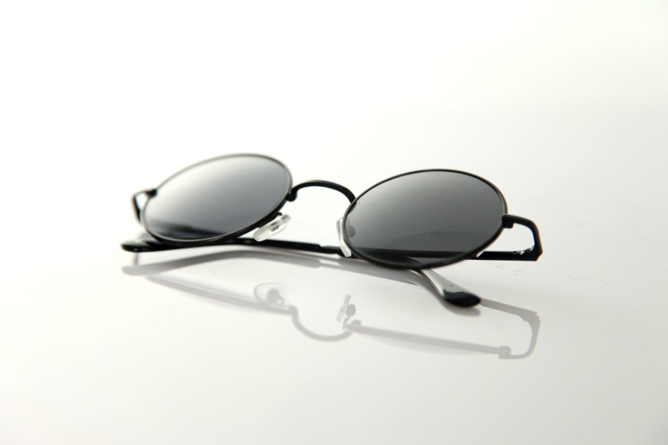 Black Frame Sunglasses On White Surface