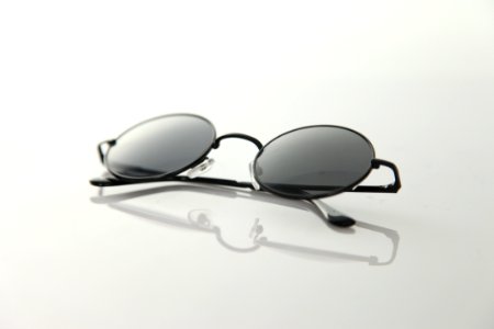 Black Frame Sunglasses On White Surface photo