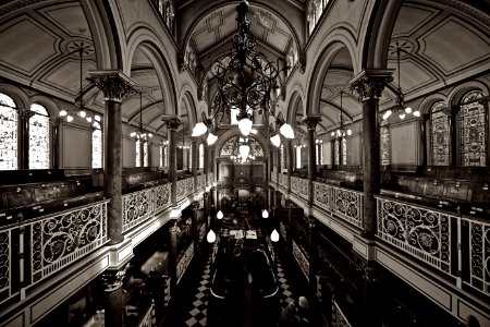 Grayscale Photo Of Chandelier Over Black Table photo