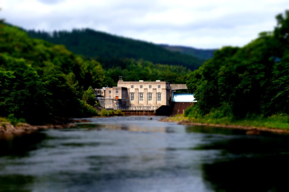 Beige House In On A Forest With River In Front