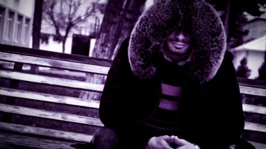 Man With Fur Collar On Bench