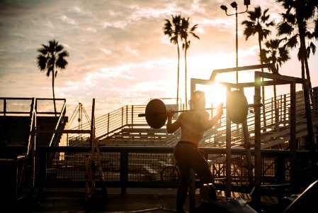 Bodybuilder Exercising At Sunset photo