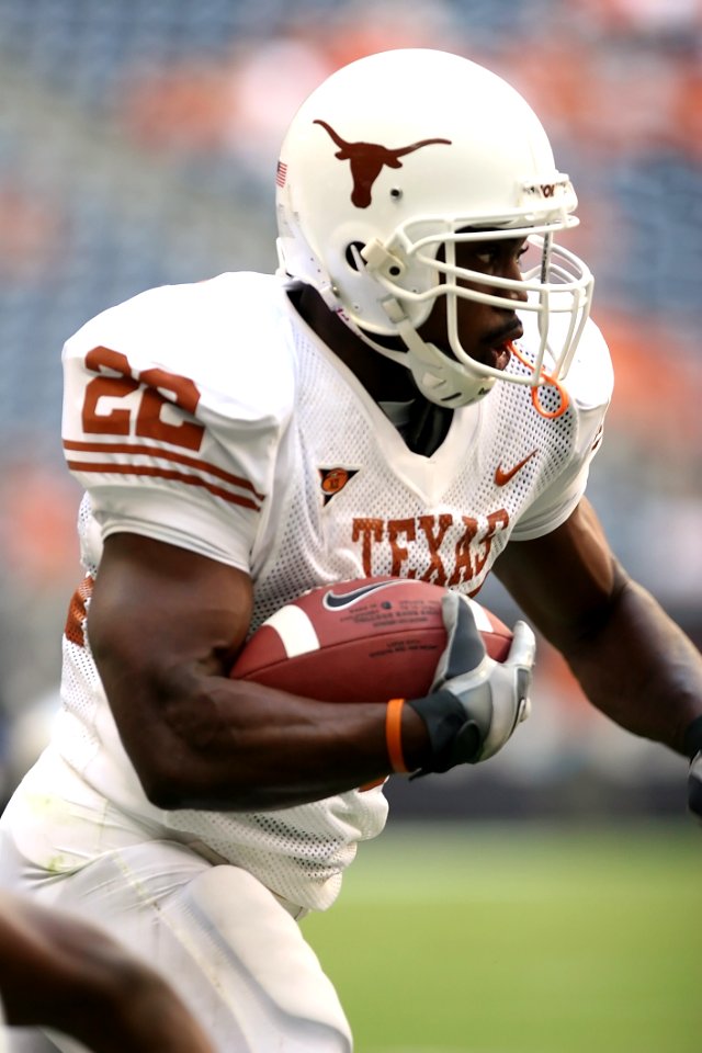 Man Wearing Texas Nike 22 Jersey Holding Ball And Running During Daytime