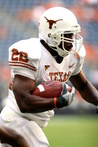 Man Wearing Texas Nike 22 Jersey Holding Ball And Running During Daytime photo