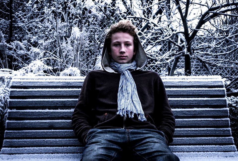 Boy On Park Bench In Winter