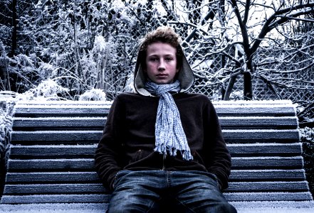 Boy On Park Bench In Winter photo