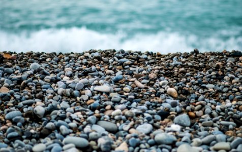 Pebbles On Seashore By Ocean photo