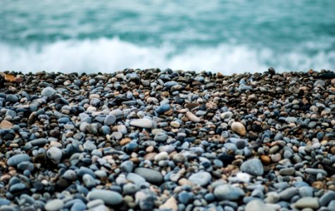 Pebbles On Seashore By Ocean