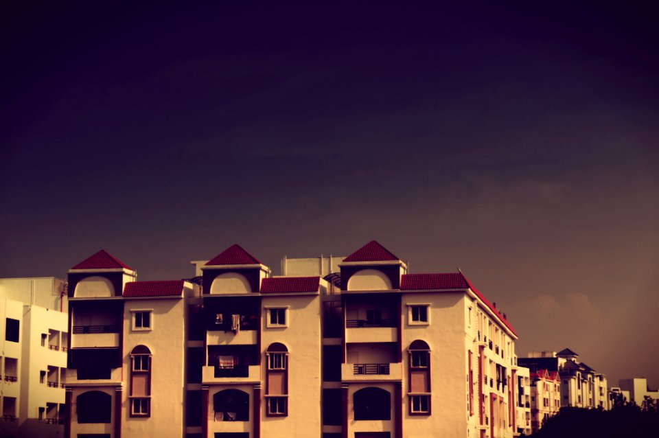 Apartment Building With Balconies At Dusk