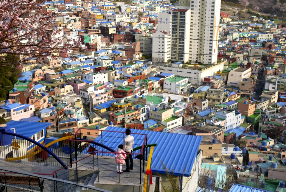 Man And Child On Staircase Overlooking Urban City