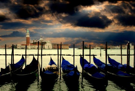 Canoes Docked In Water Near Concrete Structures