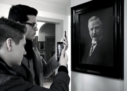 People Taking Photo Of Painting