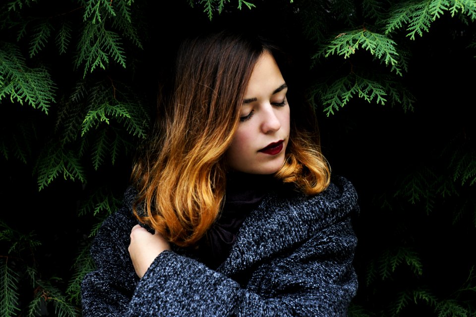 Portrait Of Young Woman In Forest During Winter