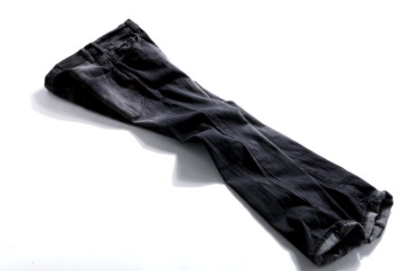 Black Denim Jeans On White Panel photo