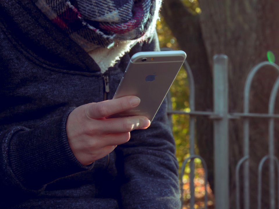 Person With Mobile Phone Outdoors photo