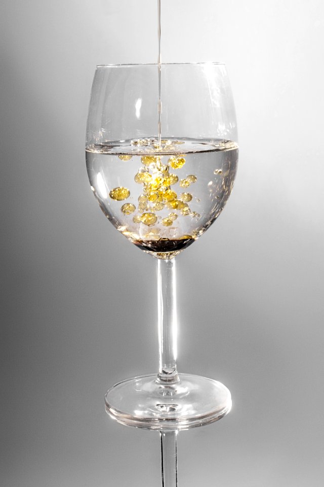 Clear Long Stem Wine Glass With Yellow Liquid
