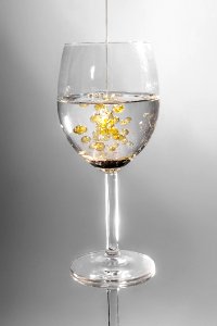 Clear Long Stem Wine Glass With Yellow Liquid photo