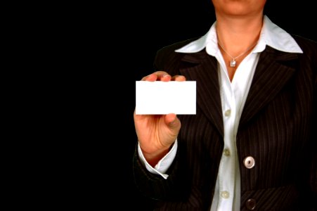 Woman In Brown Stripe Blazer Holding White Card photo