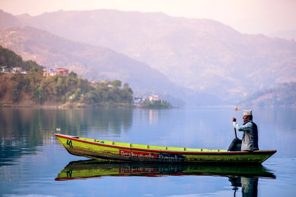 Fisherman In Boat On Lake