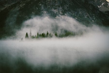 Fog Over Water By Mountain Forest photo