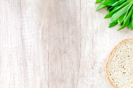 Bread And Leek On Wooden Surface