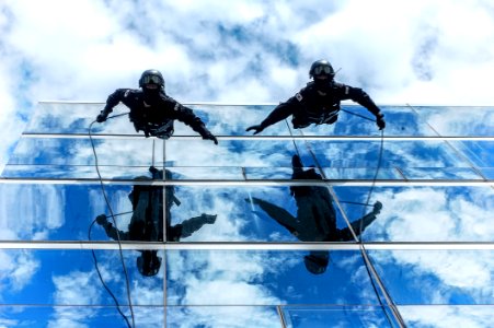 Gendarmes Climbing Down Building