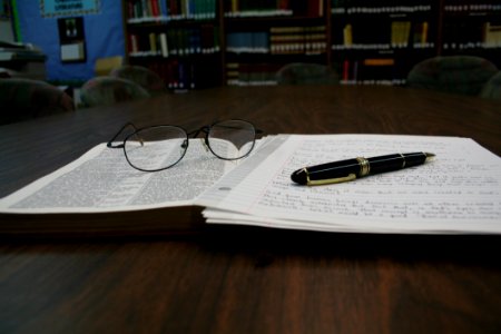 Open Book With Glasses And Pen photo