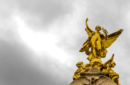 Gold Angel Statue Under Grey Clouds