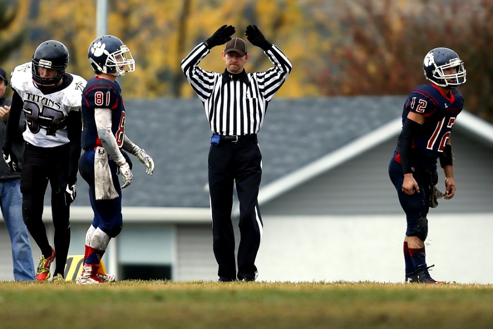 Referee Between 3 Football Player
