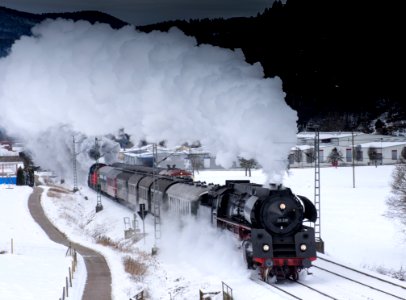Steam Engine Train On Snowy Tracks photo