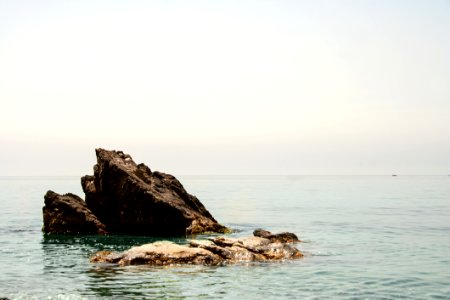 Rock Outcrop In Ocean Water photo