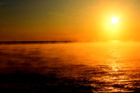 Sunset Over A Mist Covered Ocean