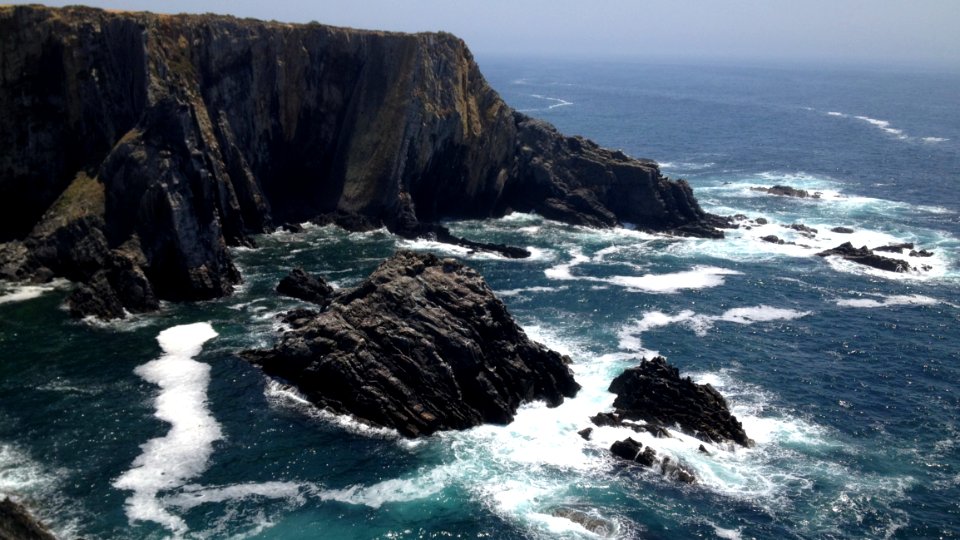 Ocean Waves Crashing Against Rocky Outcrops photo