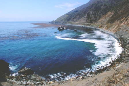 Seacoast On Hillside With Blue Water