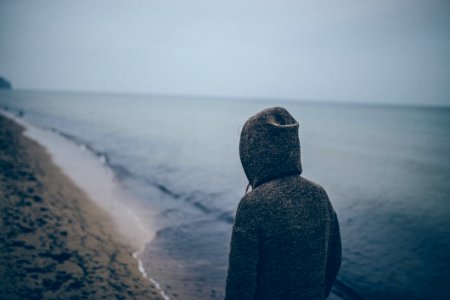 Person Walking Alone On Beach photo