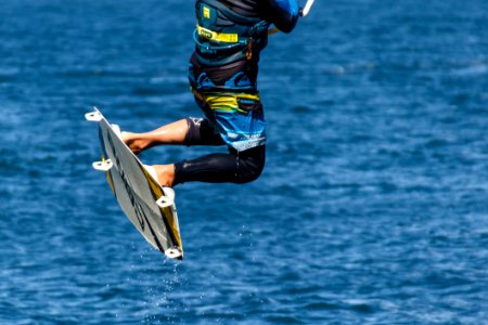 Person In Blue And Black Board Shorts On White Wake Board