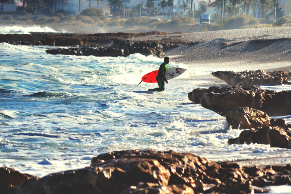 Surfer With Surfboard On Beach photo