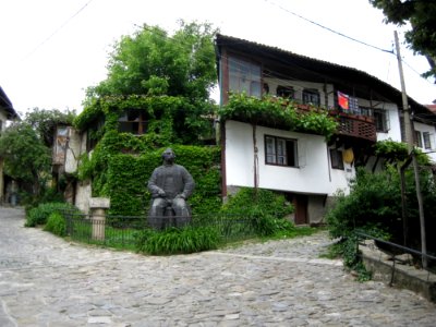 Traditional House With Statue In Garden photo