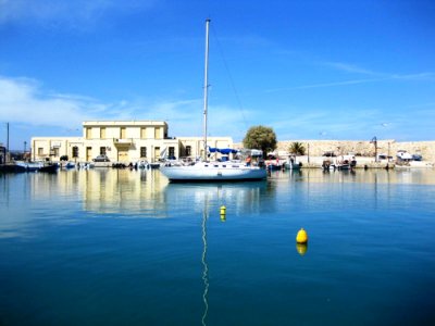 Bouy-and-mast-reflection-in-the-sea photo