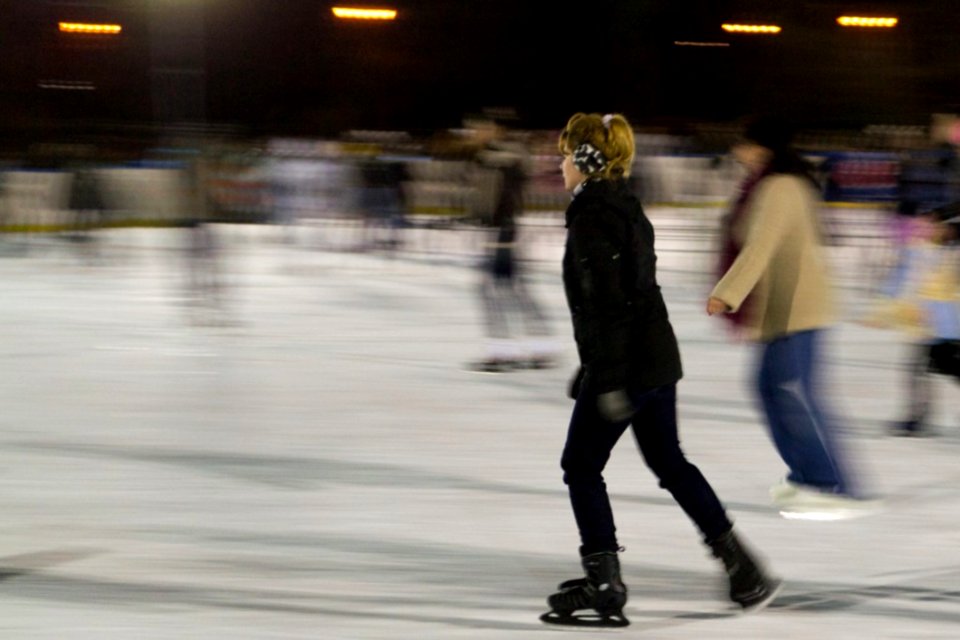 Woman-gliding-on-ice-at-skating-rink