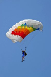 Woman Parachutist Performing At An Aerial Show photo