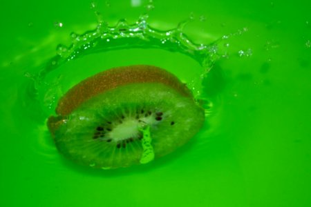 Slice-of-kiwi-hitting-water