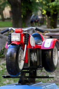 Photo Of A Motorcycle Toy In A Childrens Play Area photo