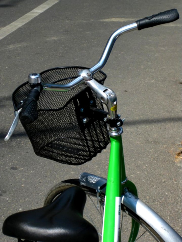 Parked-green-bicycle-with-basket
