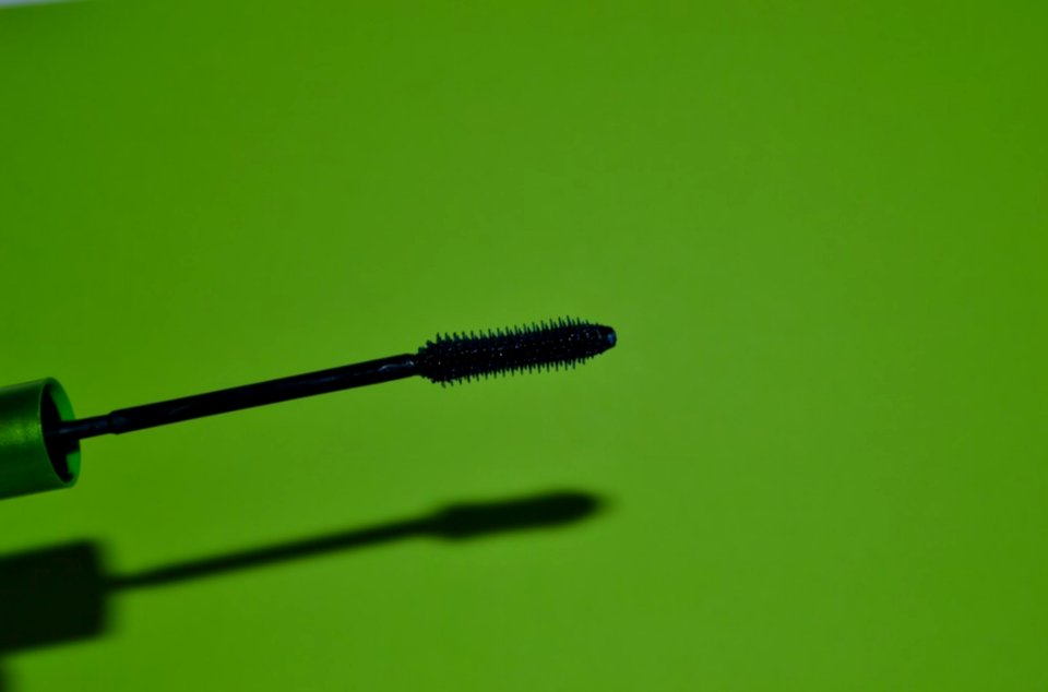 Mascara-brush-on-green-background