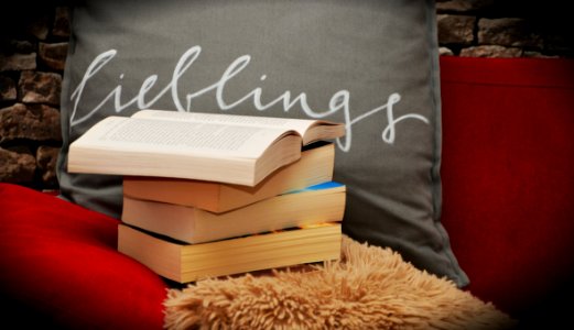 Books Pile On A Chair And Shaggy Rug
