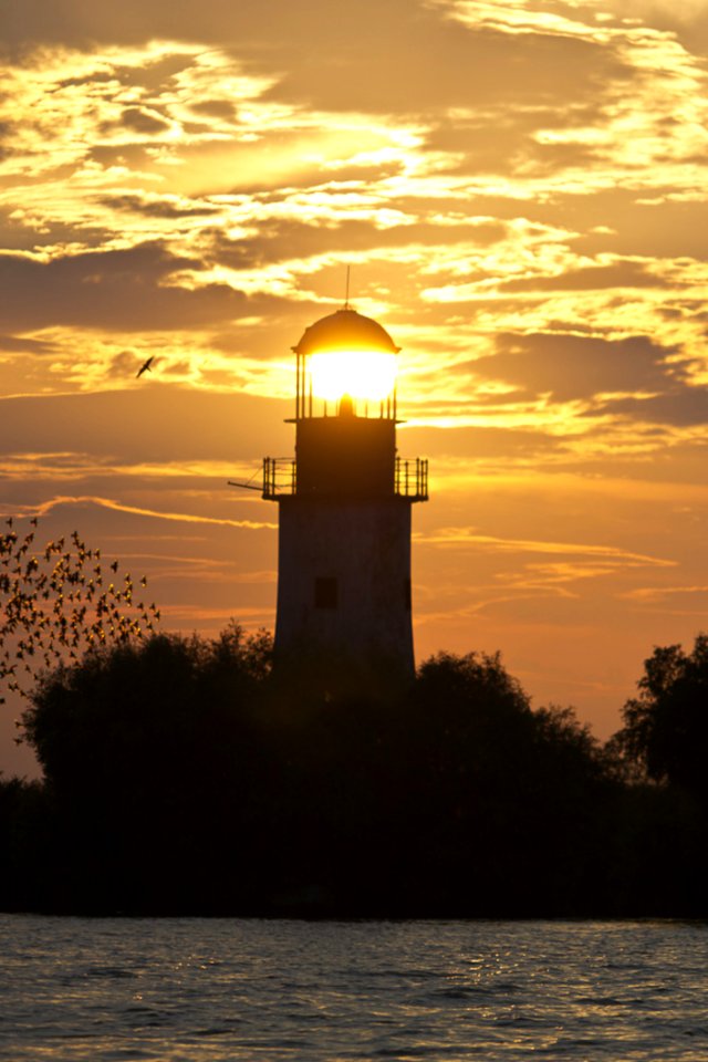 Lighthouse Lit By Setting Sun