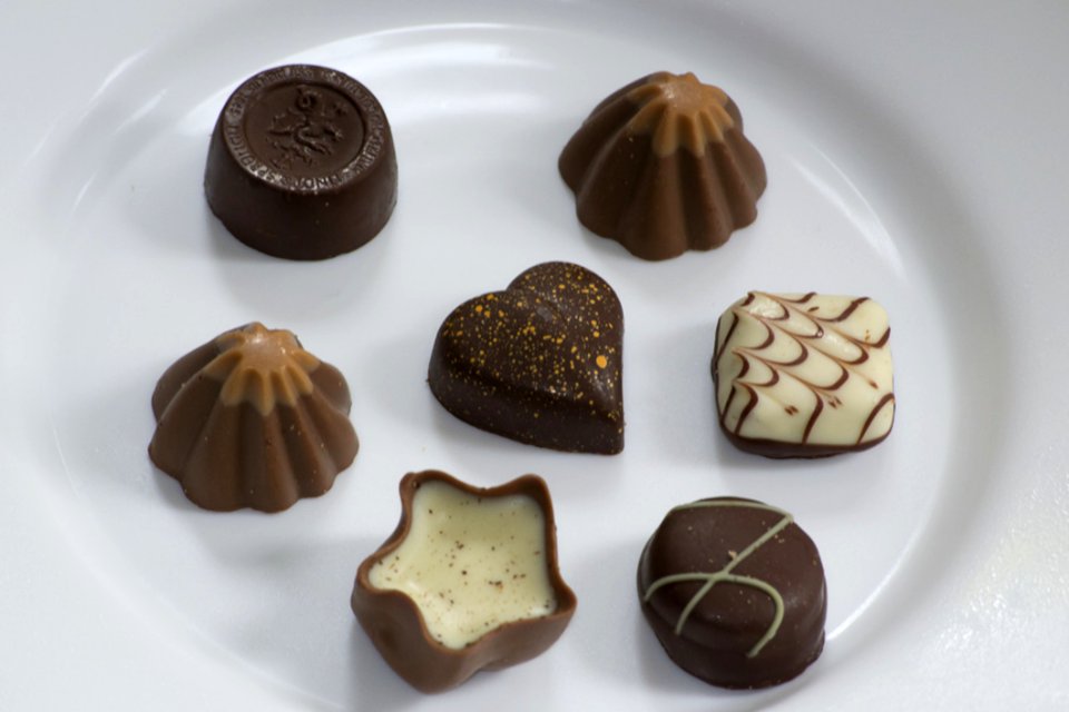 Picture Of Assorted Swiss Chocolate Bonbons Isolated On White Plate